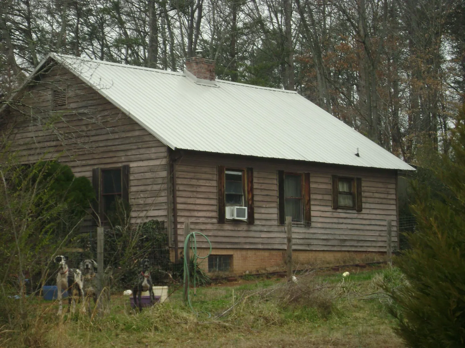 White metal roof on an old wood sided farmhouse, from a Metal Roof Installation job in Nellysford